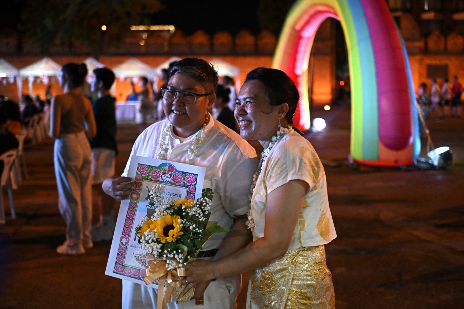 Queer Myanmar couple Nyan and Mae pose after accepting a mock marriage certificate at the LGBTQ Pride event in the northern Thai city of Chiang Mai on May 26. (AFP)