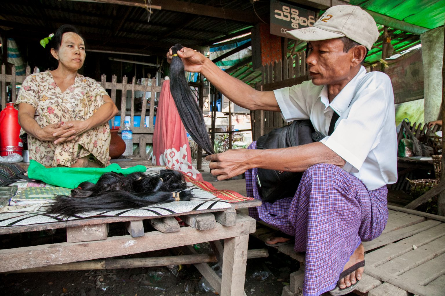 A hair merchant assesses his day’s haul at Yangon’s Insein market in 2015. (Frontier)