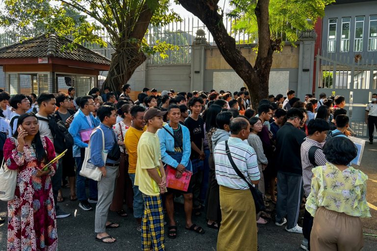 People gather outside the Thai embassy in Yangon to apply for visas on February 16, days after the regime announced it would enforce mandatory military service. (AFP)